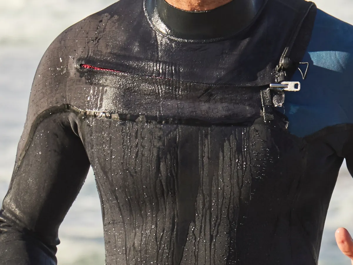 Close-up of a chest zip wetsuit showing the entry bar and chest seam construction